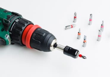 Electrician using a power drill on-site